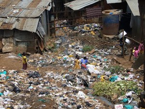 Children rummage through garbage heaps between houses in Kibera